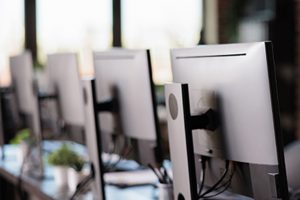 Nobody in office with multiple monitors at customer service desk